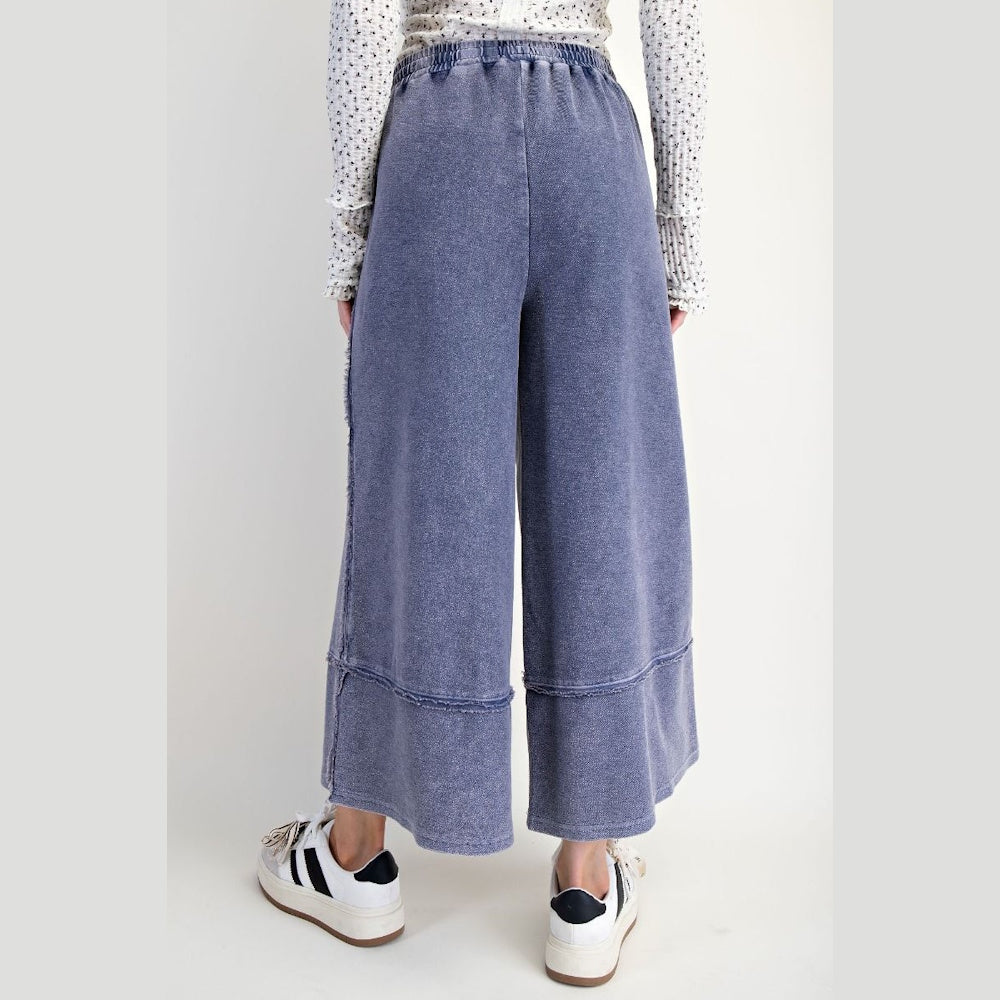 Midnight blue mineral wash palazzo pants with wide legs and raw edge seams.