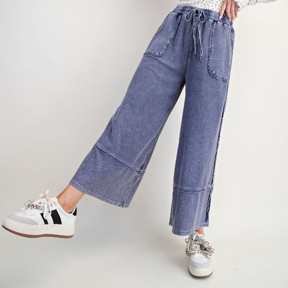 Midnight blue mineral washed palazzo pants with drawstring waist, raw edge seams, and wide leg fit for a boho style.