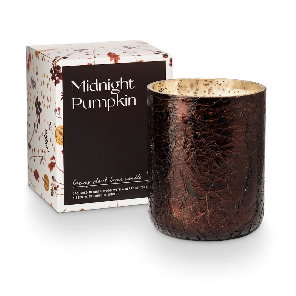 Midnight Pumpkin luxury plant-based candle in a brown crackle glass jar next to its floral gift box.