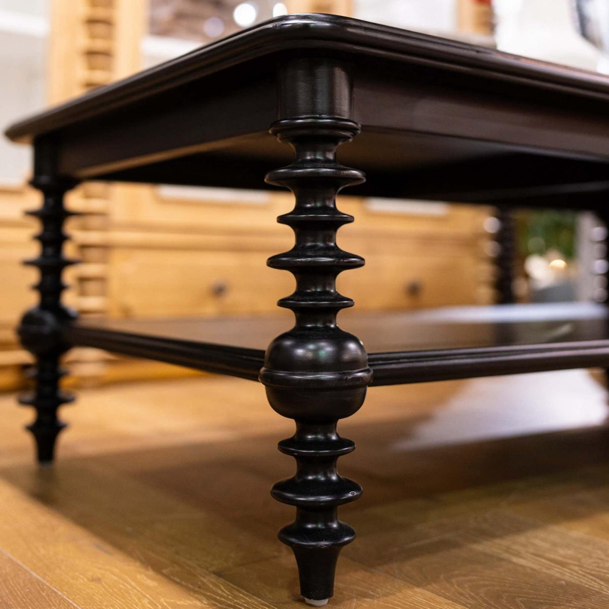 Close up of detailed turned legs on a black wooden Milano coffee table.