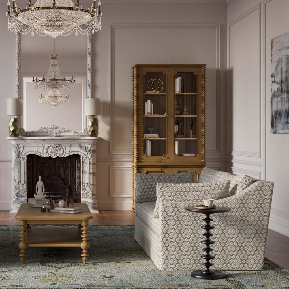 Milano round wooden side table in an elegant living room next to a patterned armchair.