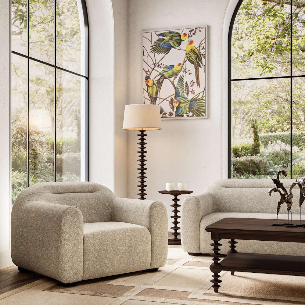Milano round side table base in a modern living room with cream boucle armchair and sofa.