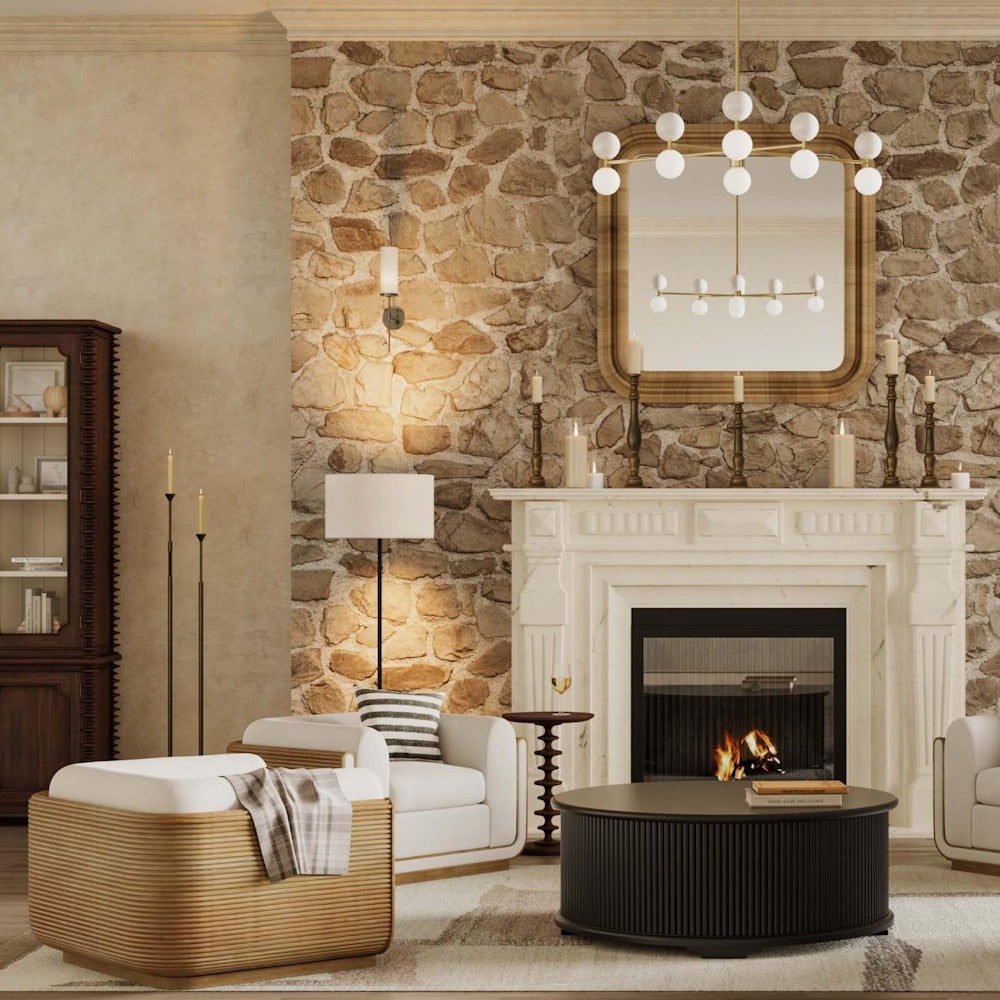 Milano round side table in a rustic living room with a stone fireplace and white armchairs.