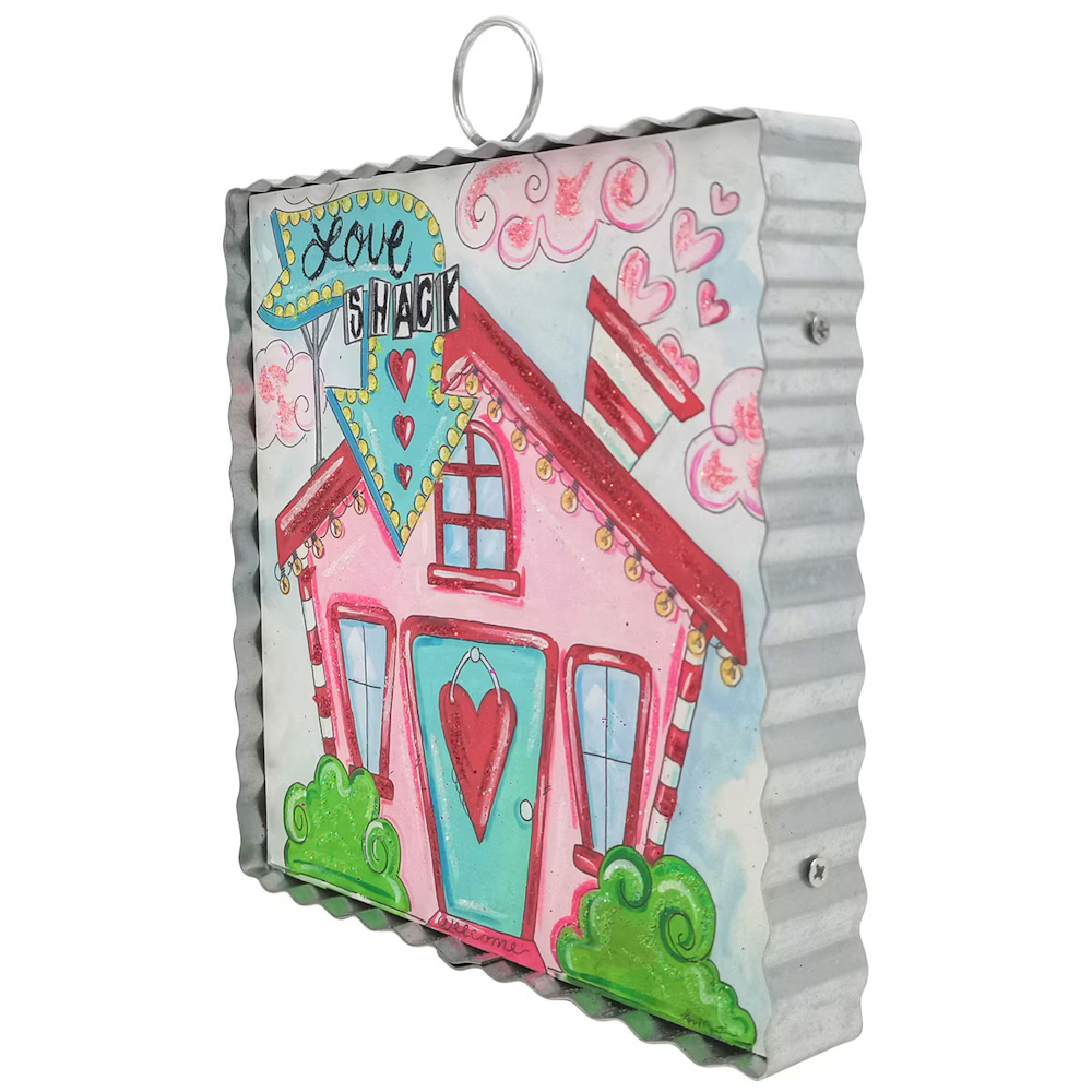 Colorful "Love Shack" pink house wall art on corrugated metal with a heart door and marquee arrow sign.