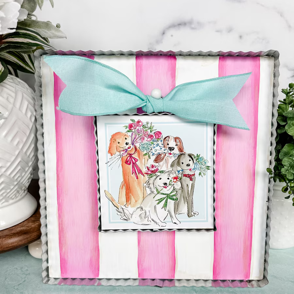 Mother's Day art featuring a watercolor illustration of four dogs with flowers on a pink striped background with a teal bow.