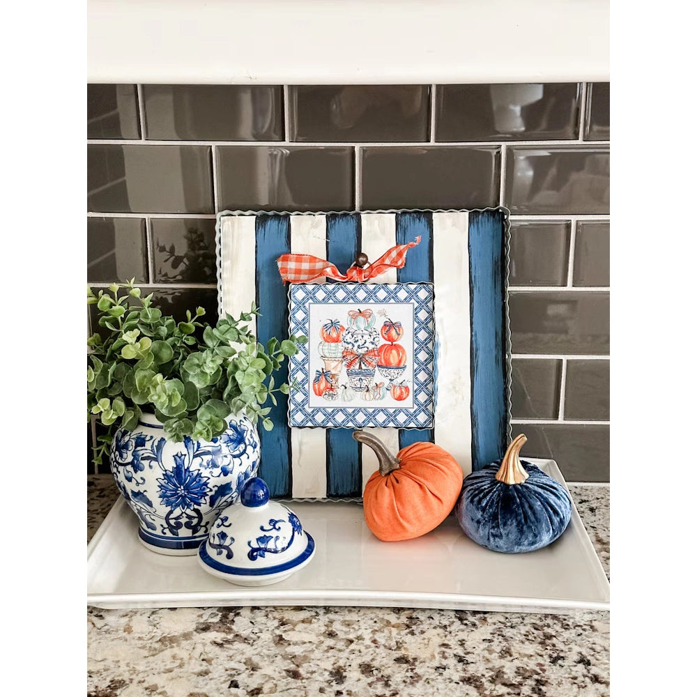 Fall tray display with pumpkin topiary art on a striped board, velvet pumpkins, and a chinoiserie ginger jar.