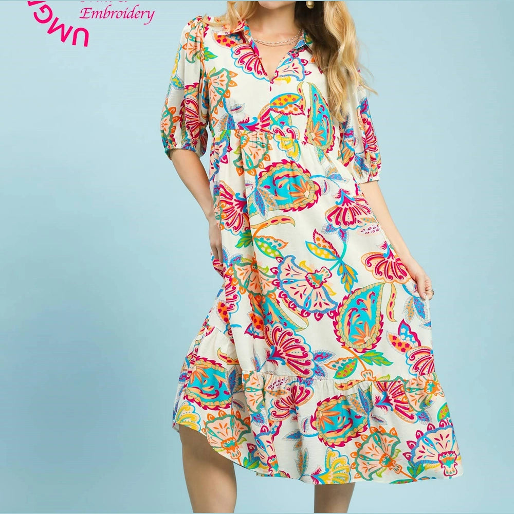 Cream cream-colored paisley print maxi dress with colorful floral patterns, V-neckline, and puff mid-length sleeves.