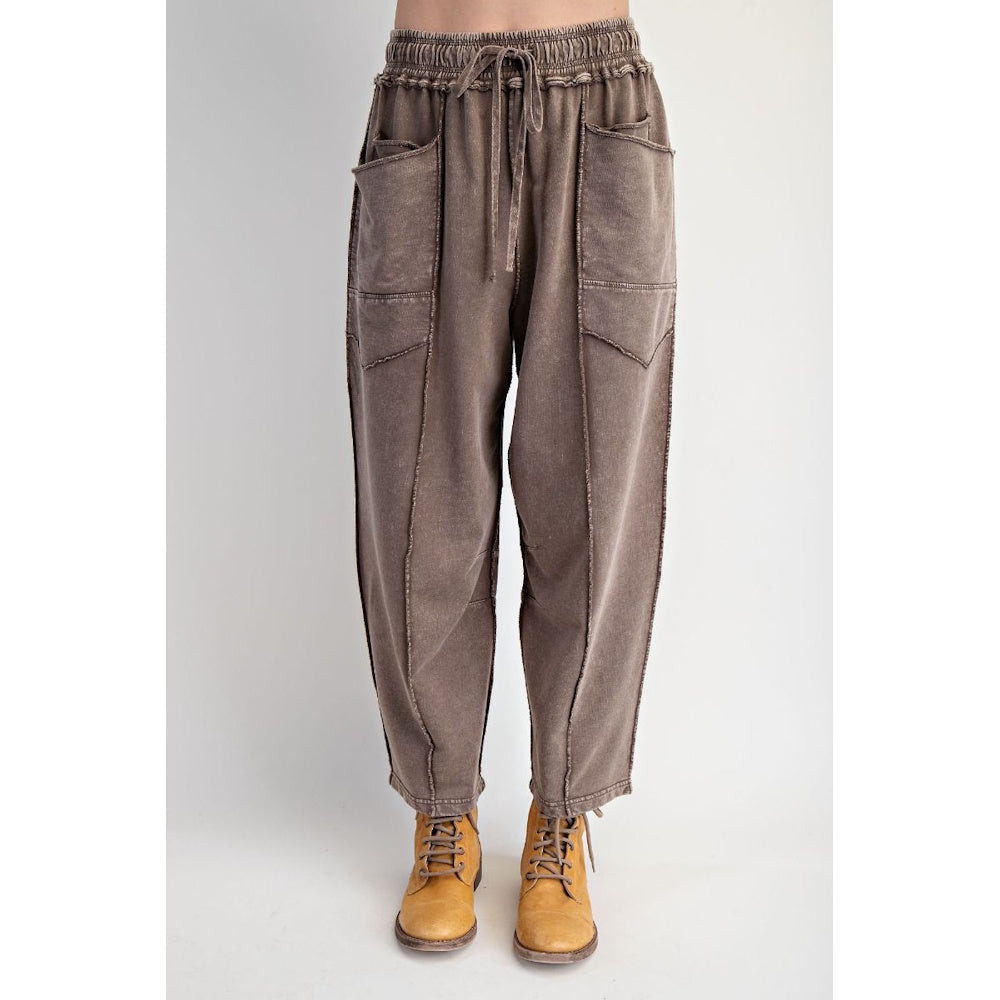 Front view of mocha mineral-washed terry knit barrel-leg pants with drawstring waist and raw-edge seam details.