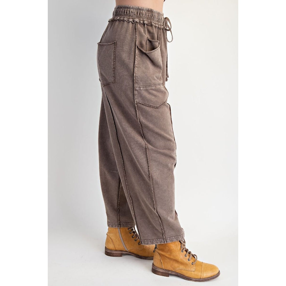 Side profile of mocha mineral-washed terry knit barrel-leg pants featuring exposed stitched seams.