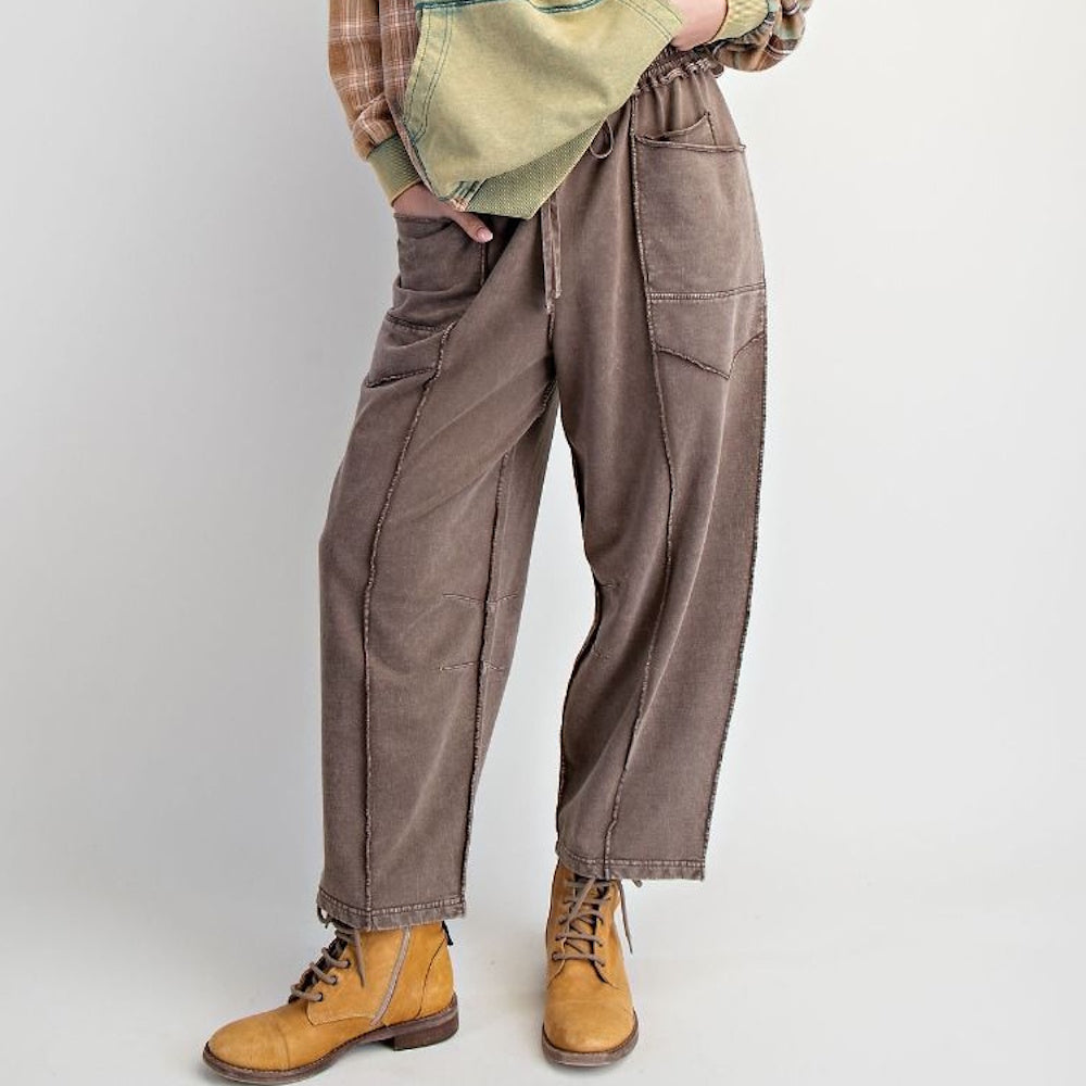 Mocha mineral-washed terry knit barrel-leg pants with drawstring waist and stitched panel details.