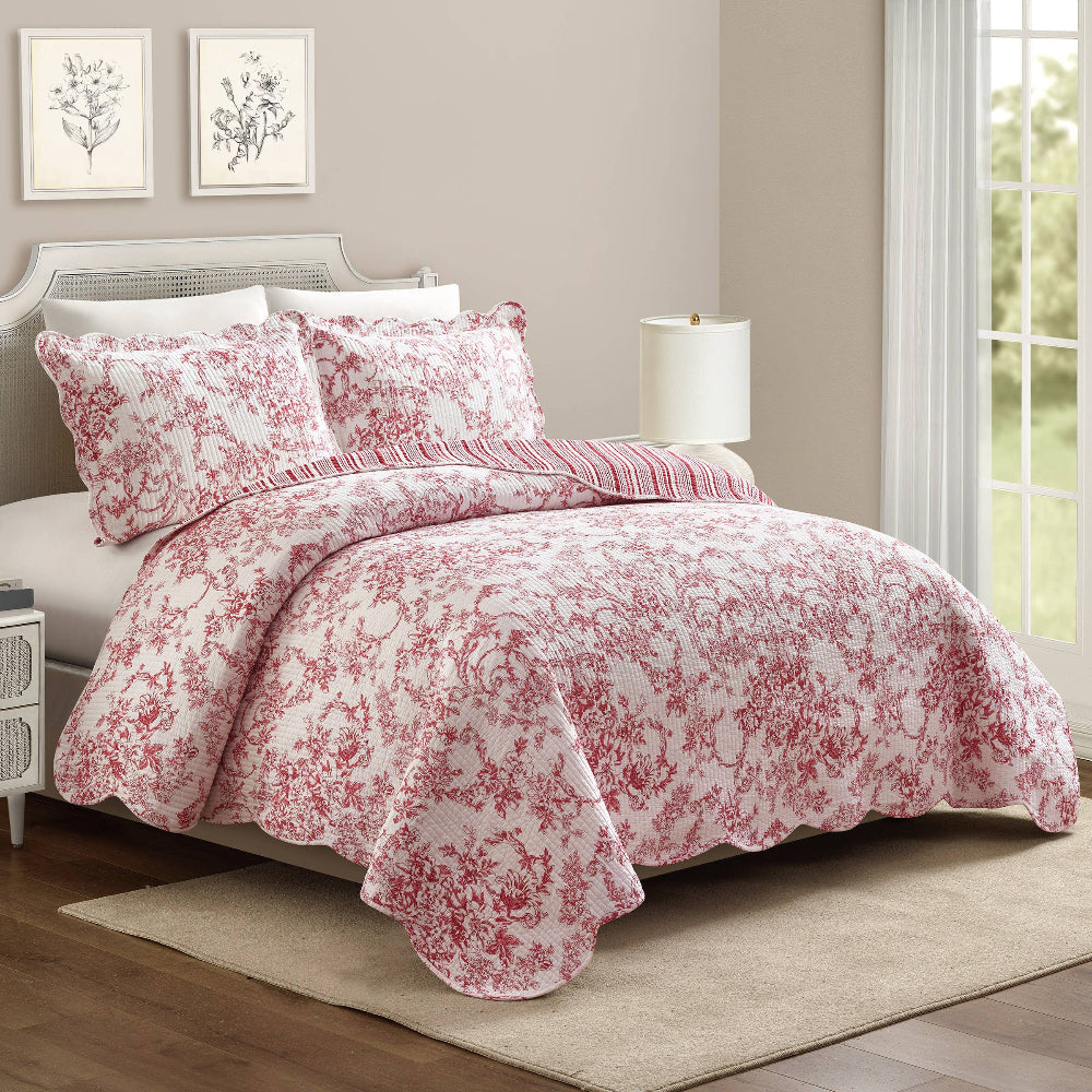 Red Garden Toile Quilt Set with scalloped edges and matching shams on a white bed, classic floral reversible bedding.