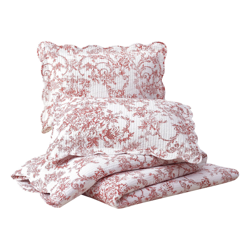 Red and white floral garden toile quilt set with scalloped edges and matching pillow shams, modern heirloom bedding style.