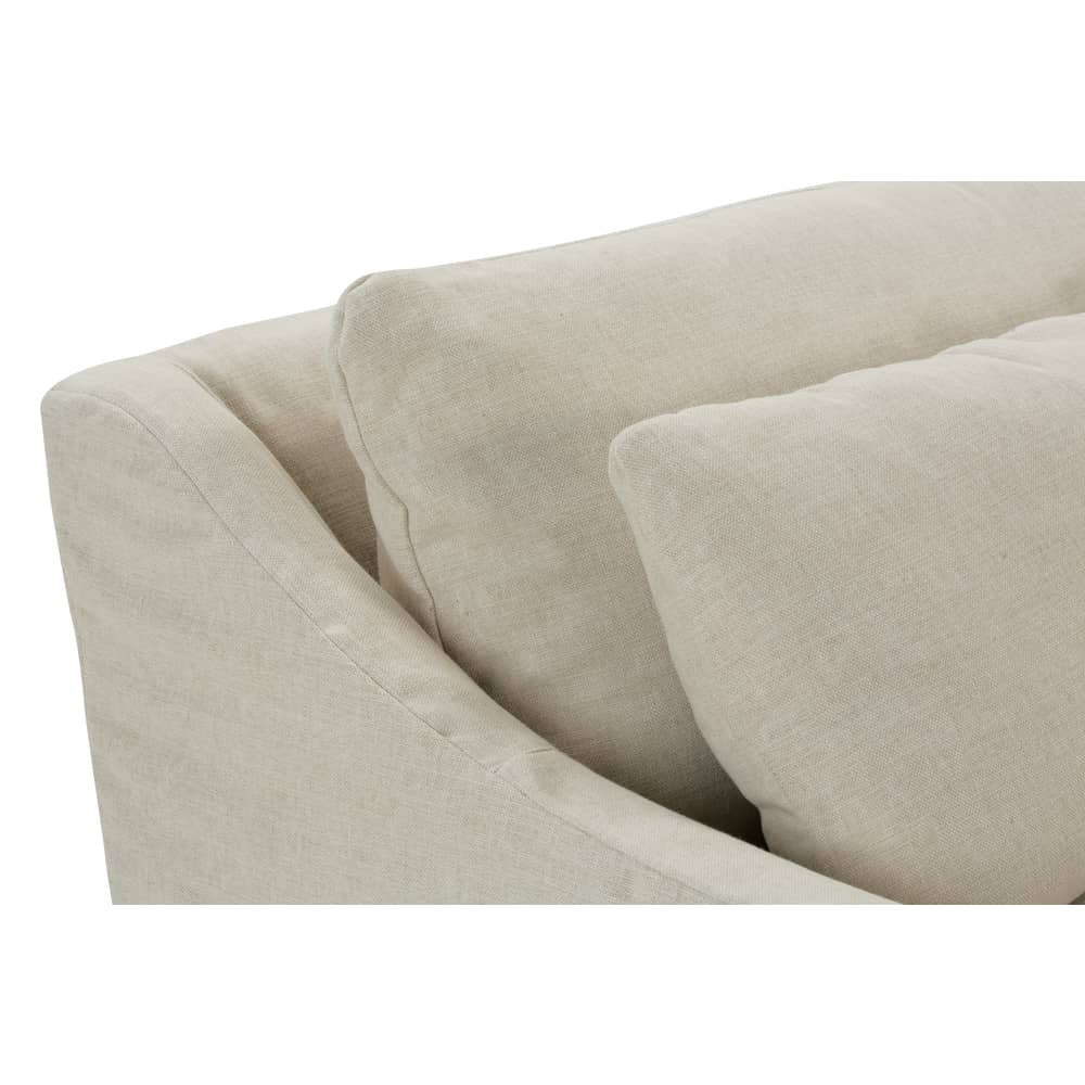 Close-up side view of the Moreau beige slipcovered couch backrest and plush linen cushions.