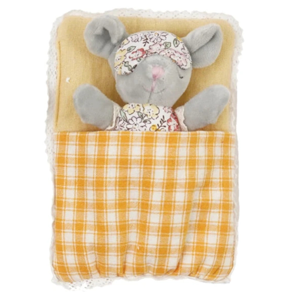 Small plush mouse wearing a floral eye mask sleeping in a yellow plaid sleeping bag with lace trim.