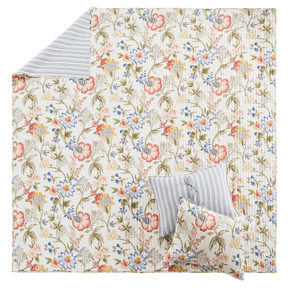 Multicolor floral quilt set featuring a blue-and-white striped reverse and matching decorative pillows.