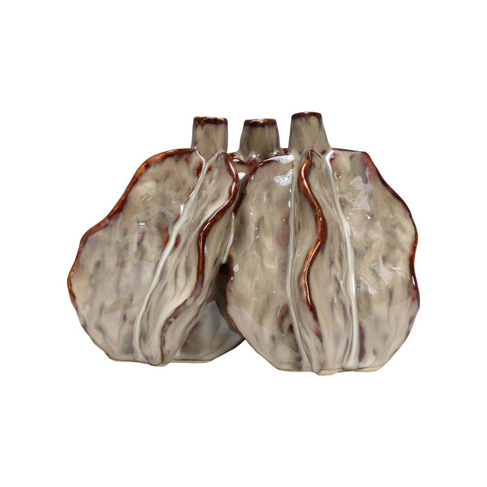 A cluster of three interconnected beige ceramic vases with wavy edges and brown trim.