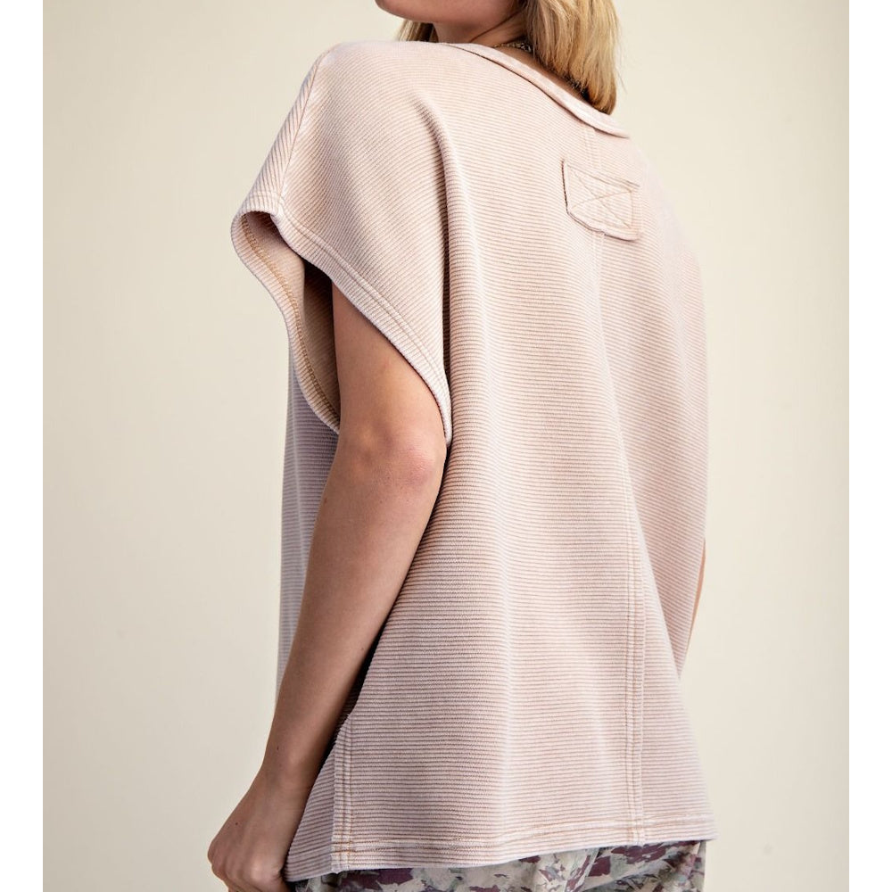 Back view of a light beige, textured drop-shoulder top with short cap sleeves and a relaxed fit.