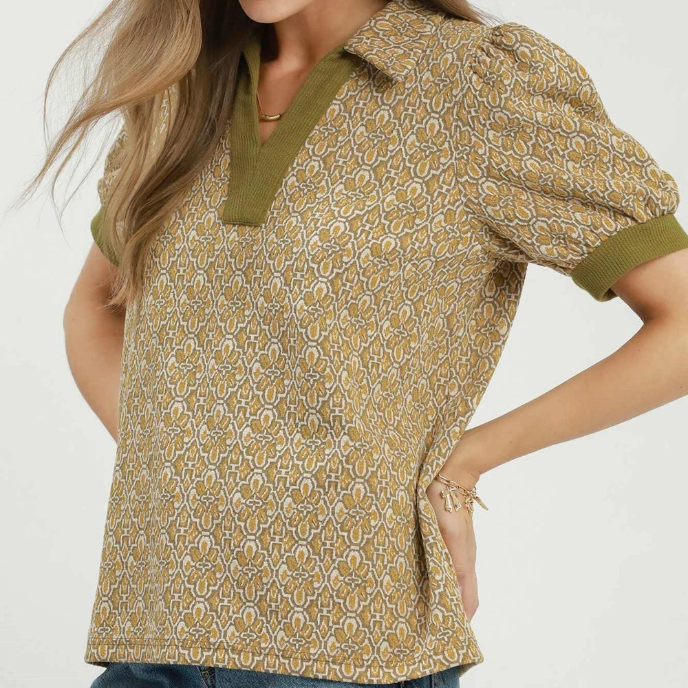 Mustard patterned collared top featuring short puff sleeves with olive green ribbed trim.