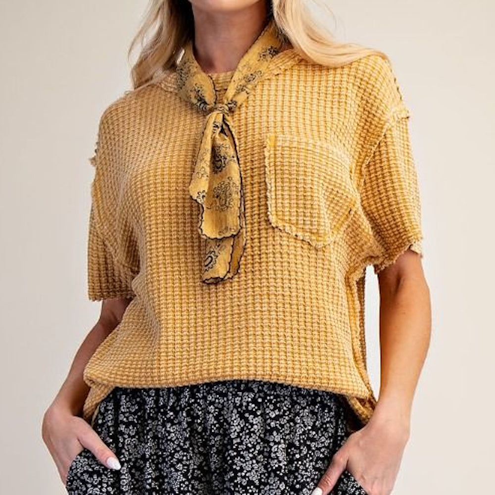 Mustard yellow short-sleeve waffle knit top with a front pocket and matching patterned neck scarf.
