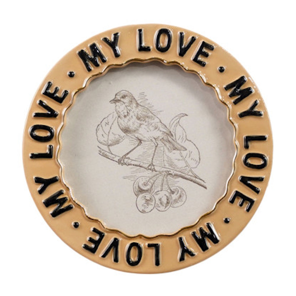 Round ceramic frame with 'MY LOVE' text around a central sketch of a bird perched on a branch.