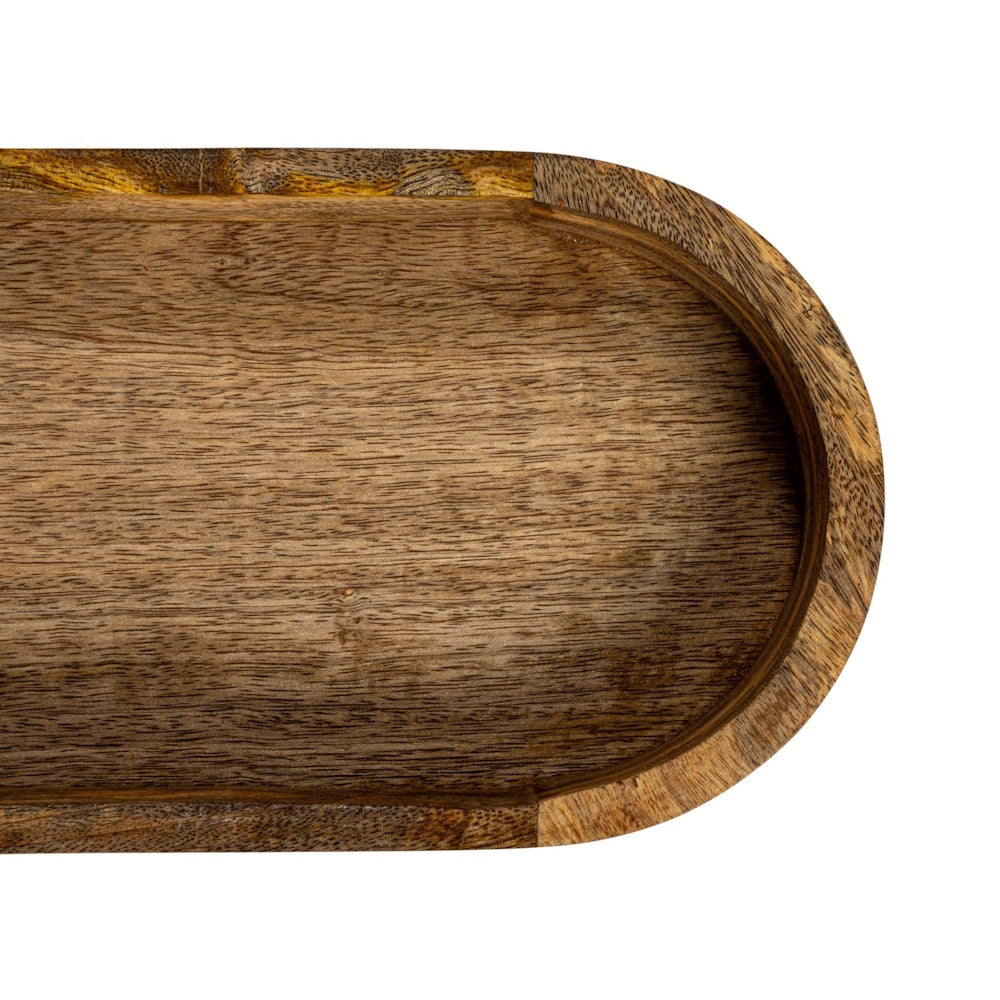 Top-down close-up of a natural mango wood tray with a curved edge and rich grain texture.