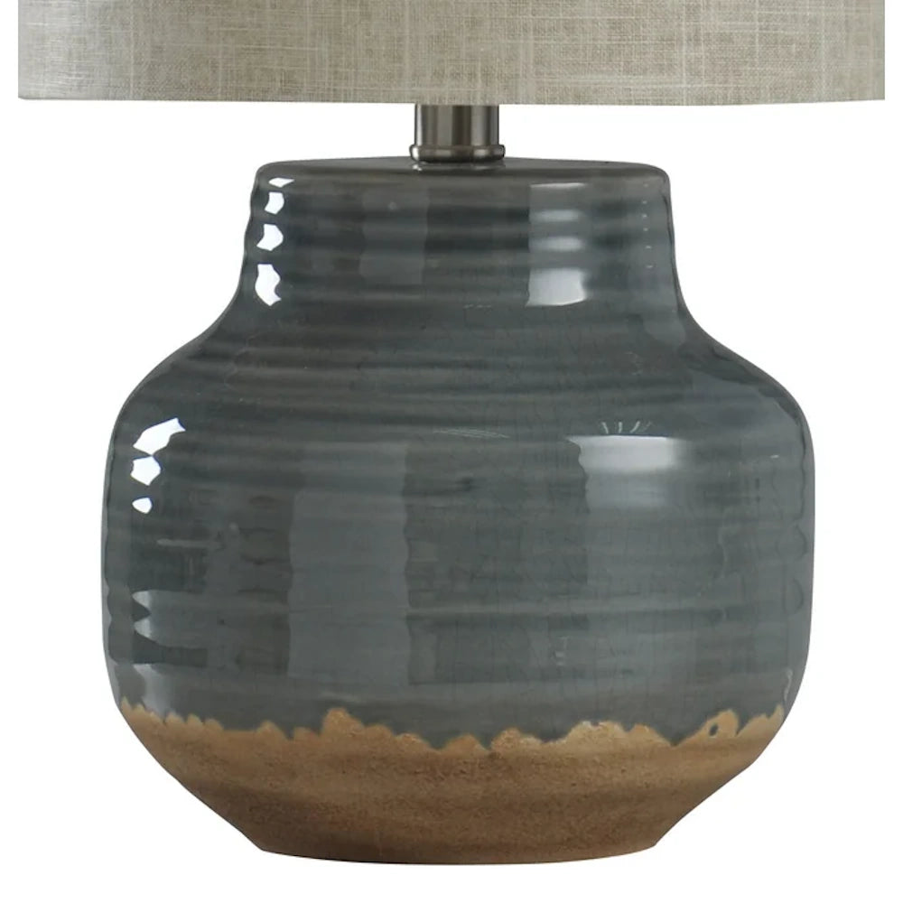 Glossy gray ceramic table lamp base with horizontal ridges and a natural tan stone-look bottom.