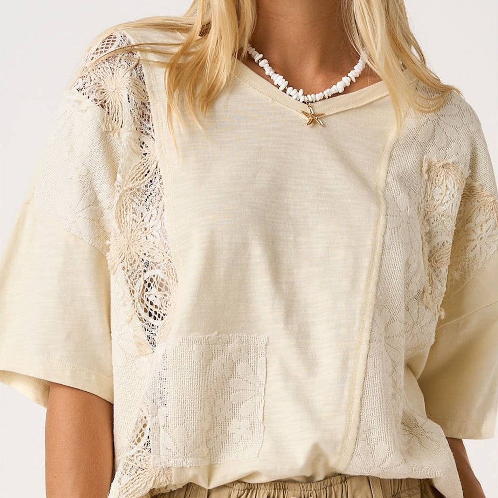 Women's natural cream short sleeve top with boho patchwork lace inserts and a relaxed V-neck fit.