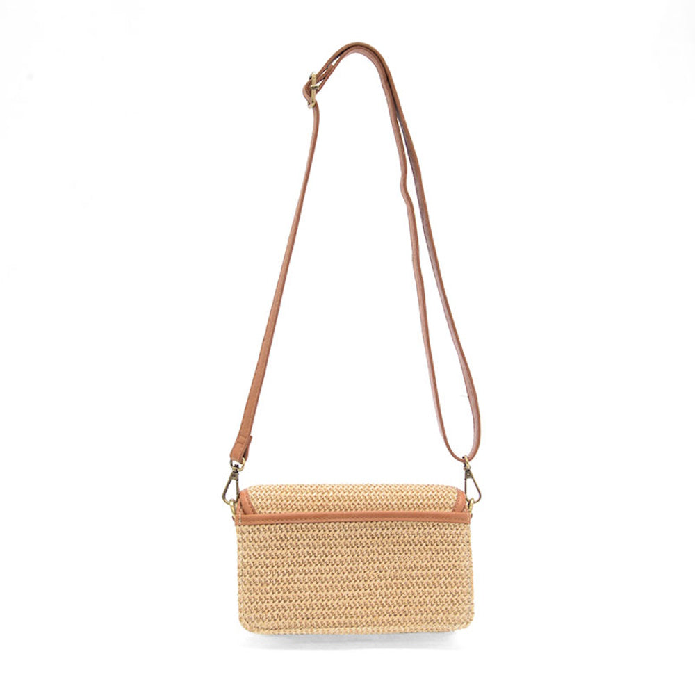 Woven straw crossbody bag with a tan leather strap and trim, shown from the back against a white background.