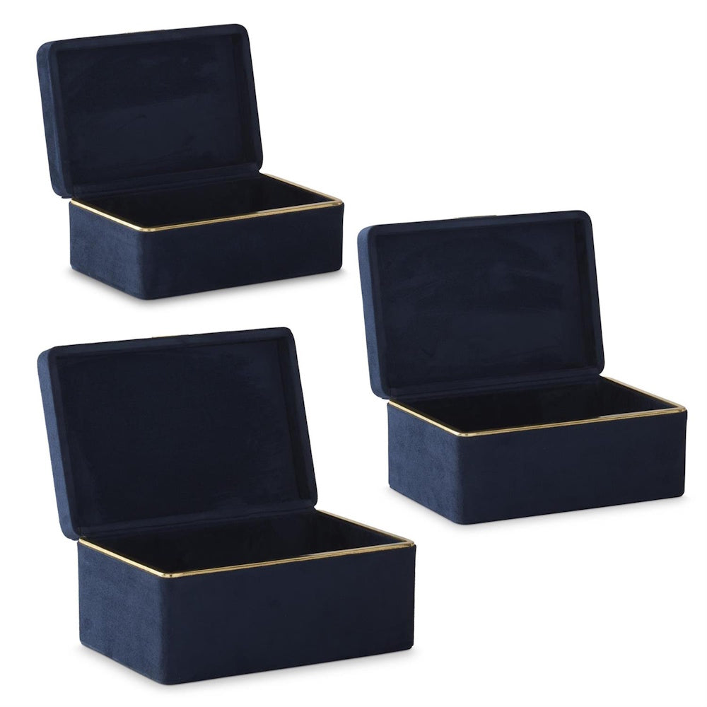 Three open navy blue suede boxes with gold trim.