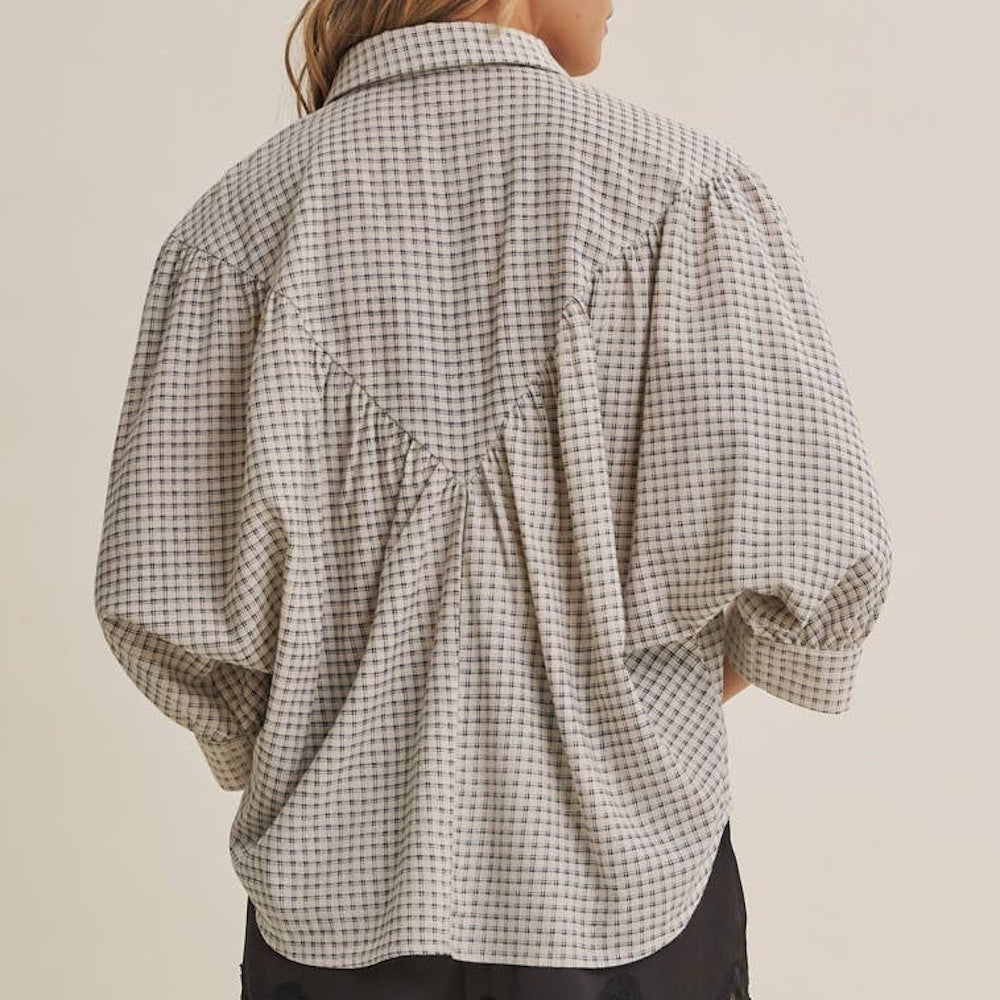 Back view of a micro-grid plaid shirt featuring a V-shaped gathered yoke and relaxed sleeves.