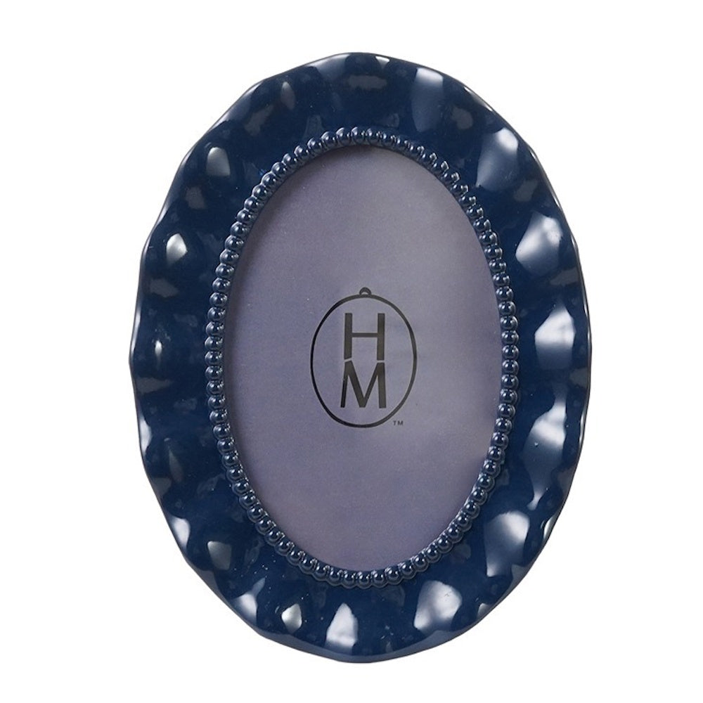 Navy blue oval photo frame with wavy, scalloped edges and a beaded inner border.