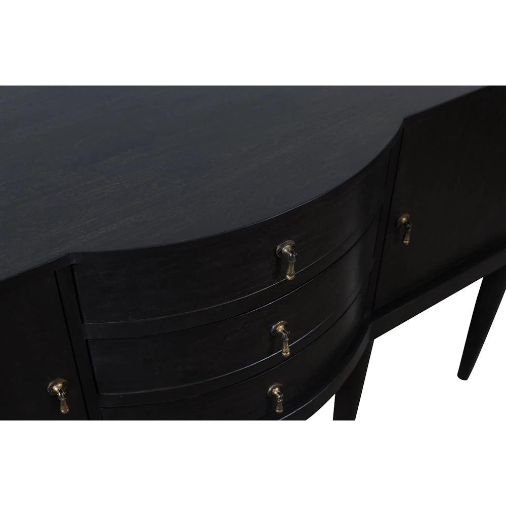Close up of black wood sideboard featuring curved drawers, brass pulls and a sleek modern design.