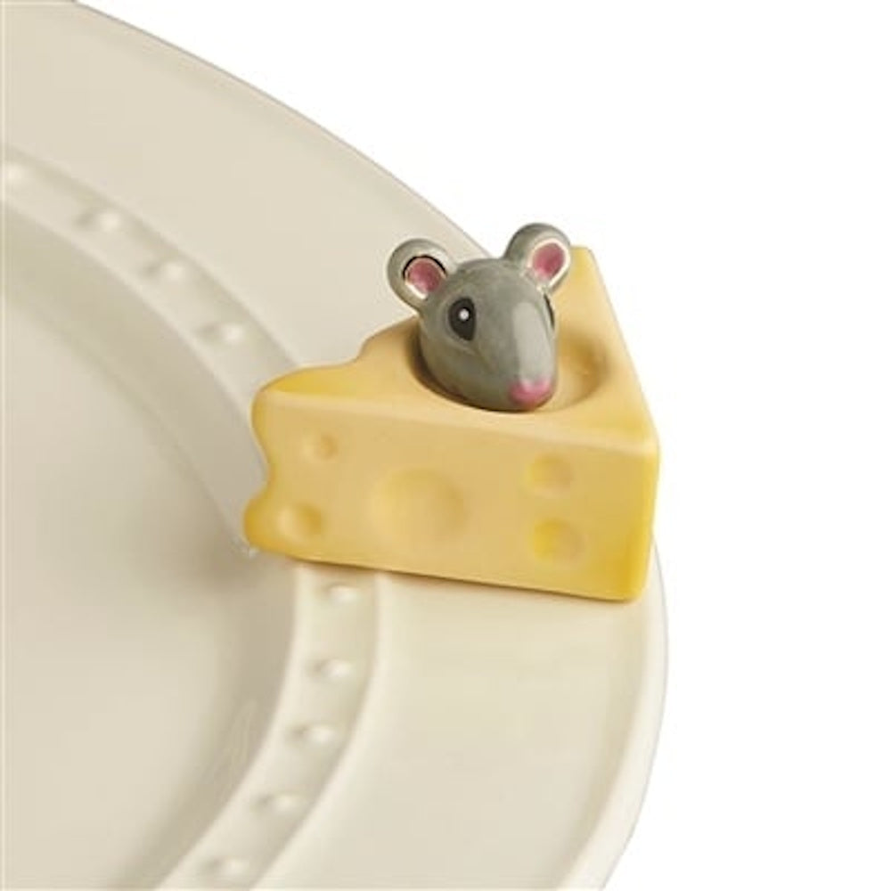 A ceramic grey mouse peeking out of a yellow Swiss cheese wedge attached to the rim of a white platter.