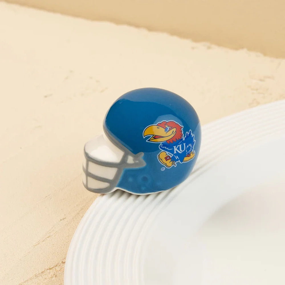 Ceramic University of Kansas football helmet figurine attached to the rim of a white platter.