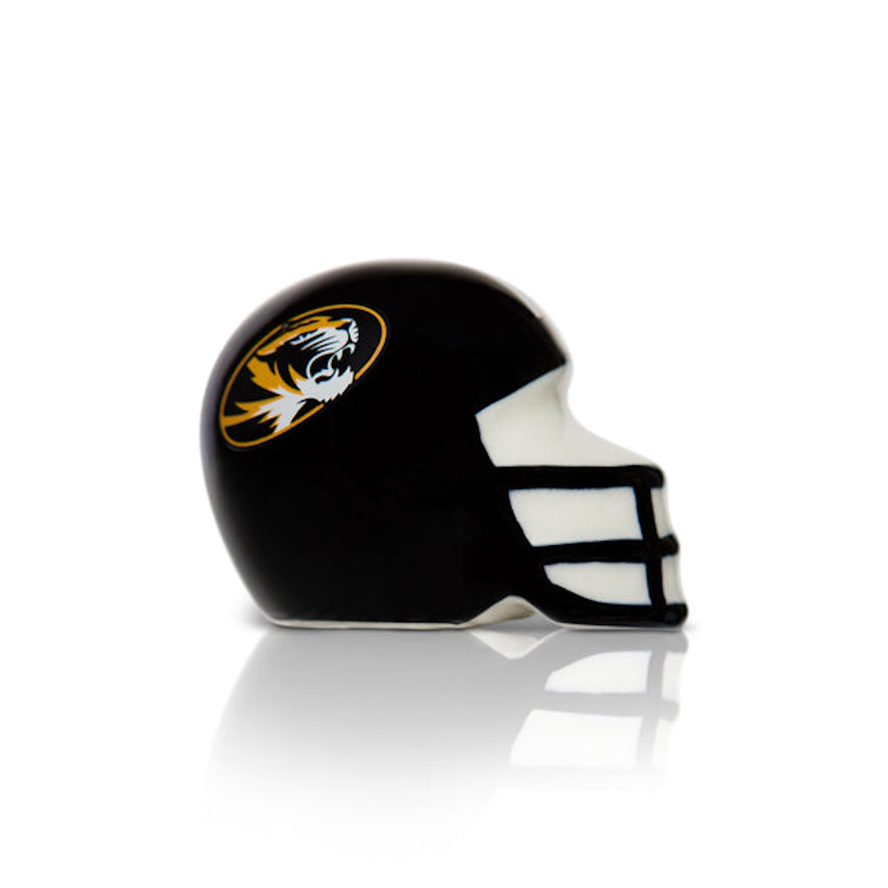 A miniature black ceramic football helmet featuring a Missouri Tigers logo on a white background.