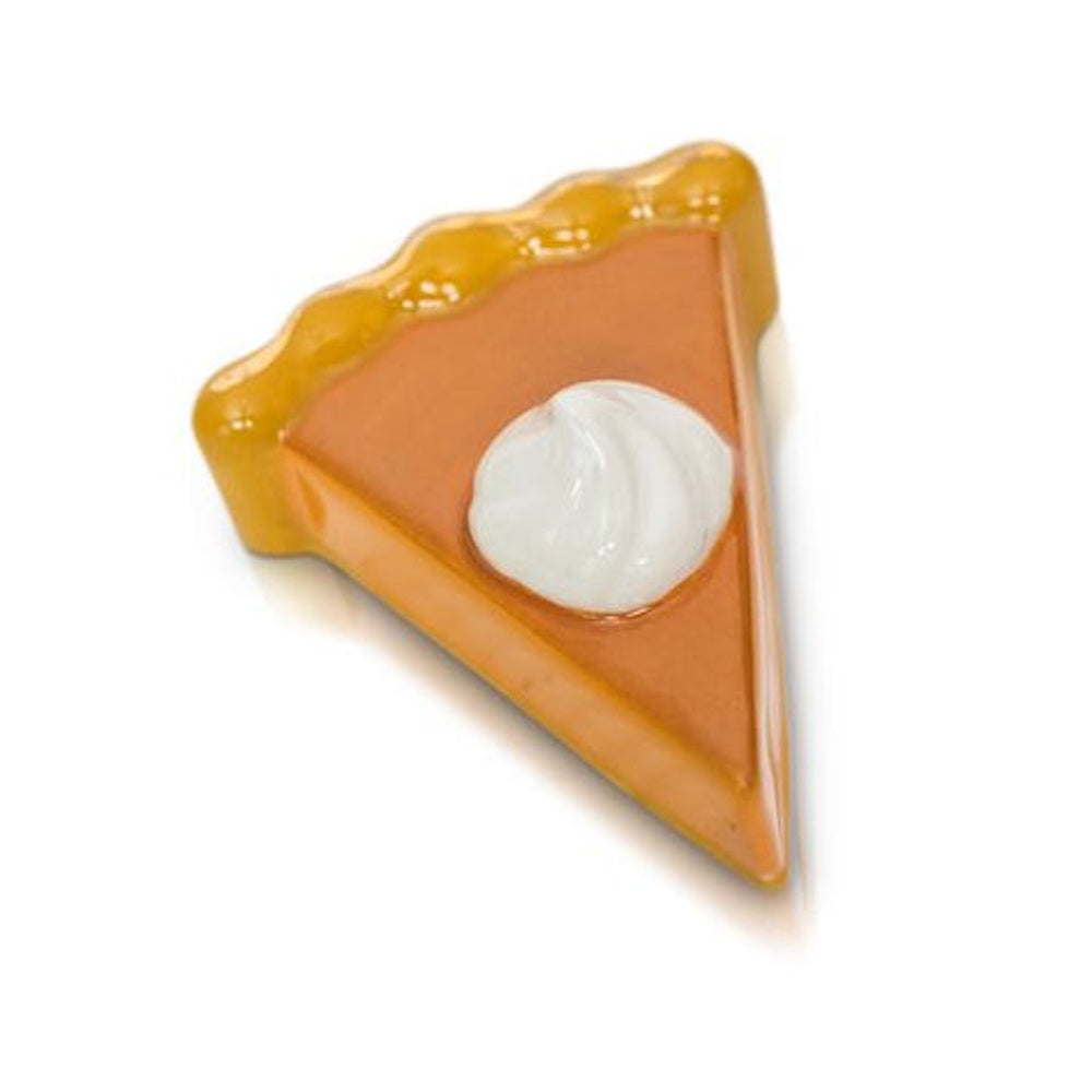 A small ceramic slice of pumpkin pie with a dollop of whipped cream on top on white background.