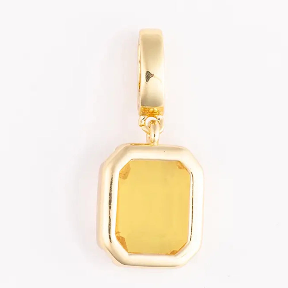 Gold pendant charm featuring a rectangular, emerald-cut yellow gemstone set in a bezel frame.