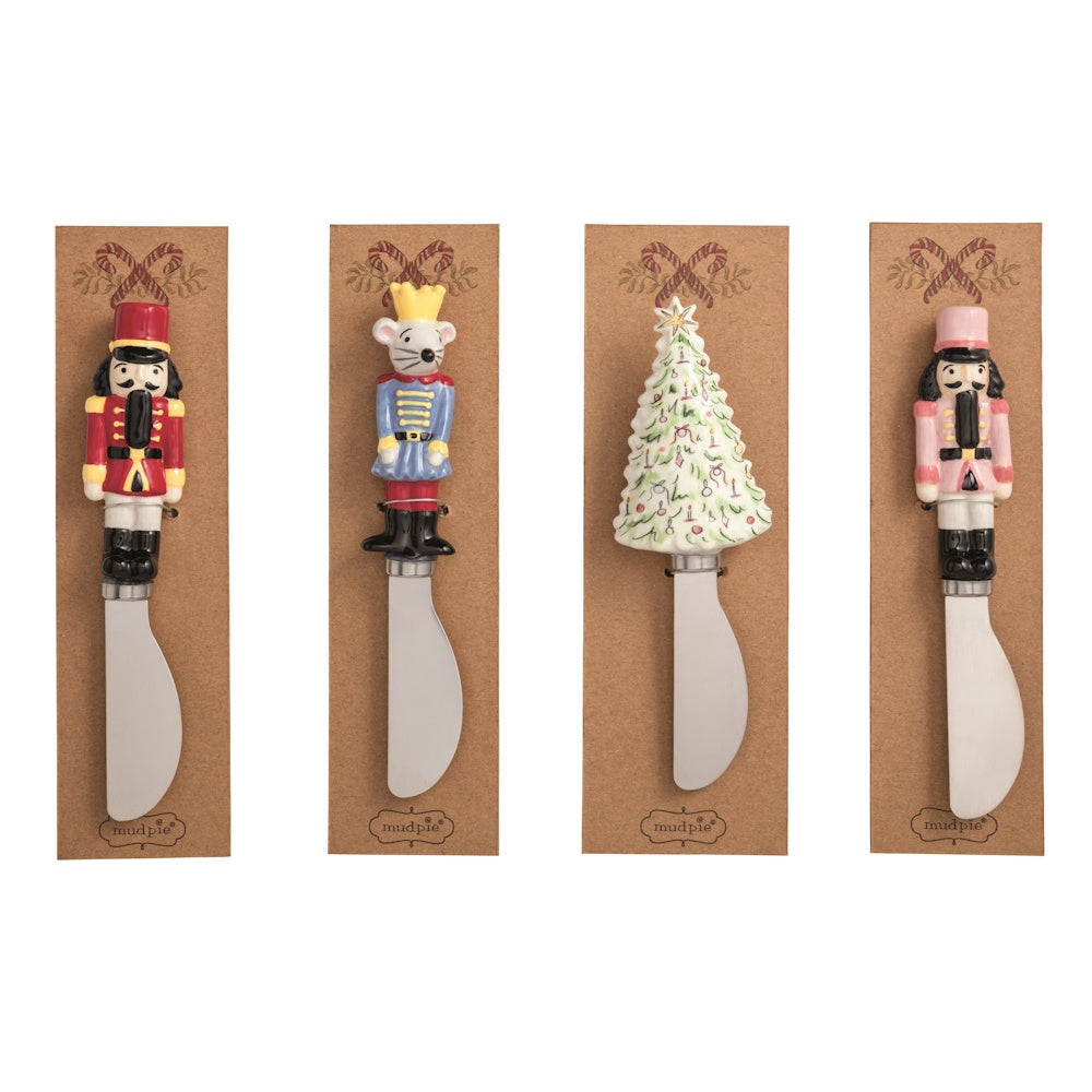Four Christmas spreaders with handles shaped like a nutcracker, mouse king, tree, and pink nutcracker.