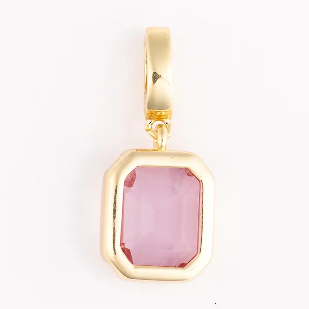 Gold pendant charm featuring an emerald-cut soft pink gemstone set in a bezel frame.