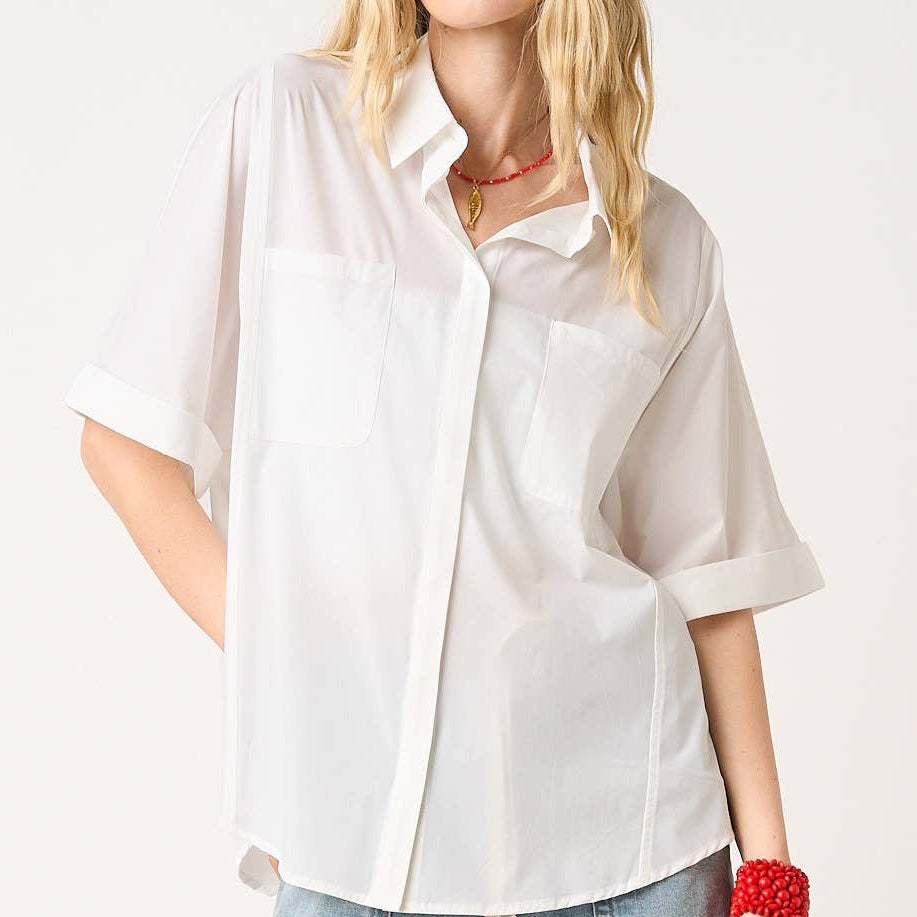 Off-white soft stretch woven short sleeve button down shirt with front pockets and cuffed sleeves for a relaxed fit.