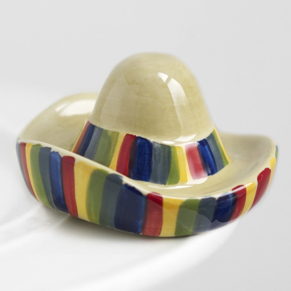 A small, ceramic sombrero-shaped dish with colorful vertical stripes on a white background.