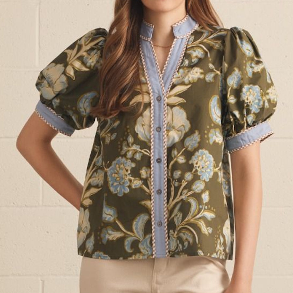 Front view of an olive green floral print top with short puff sleeves and a light blue button placket.