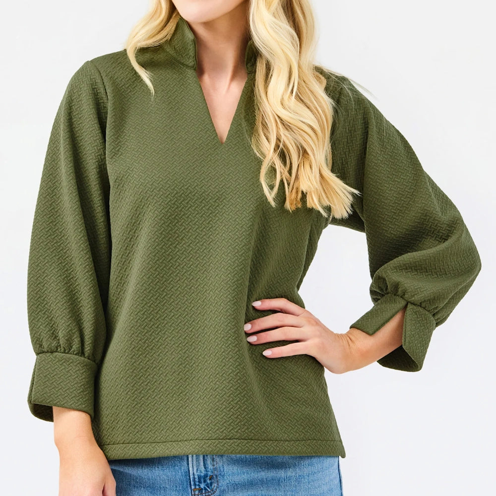 Front view of the olive green textured blouse featuring a V-neck, stand collar, and long sleeves on a white background.