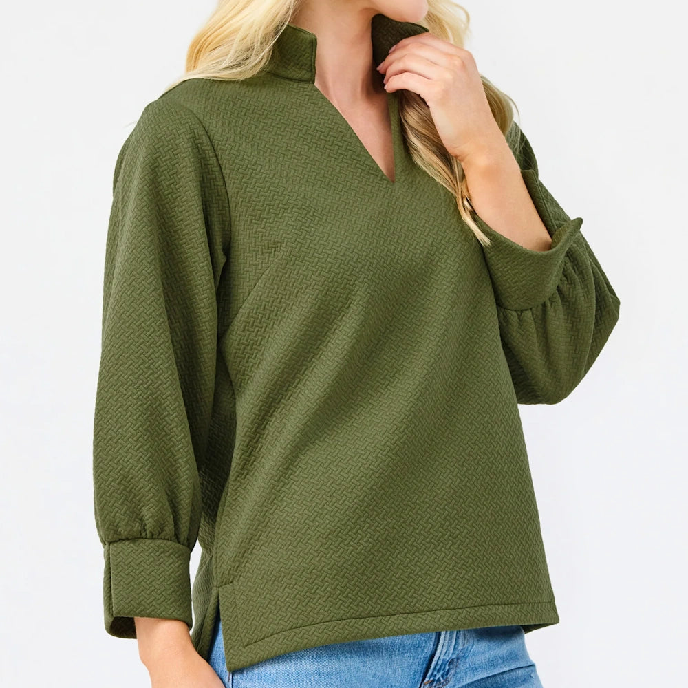 Side profile of the olive green textured blouse showing long sleeves and hem on a white background.
