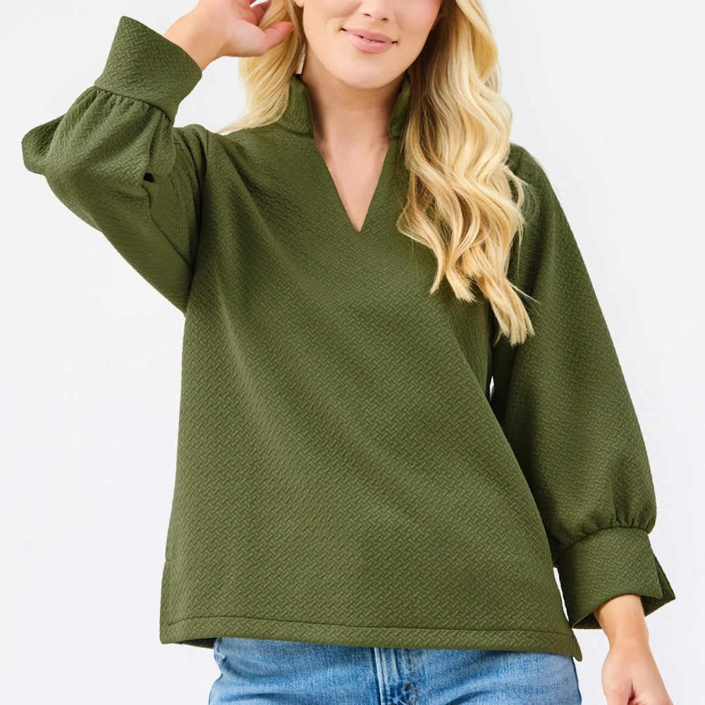 Olive green textured blouse with a V-neck, stand collar, and long balloon sleeves with wide cuffs.