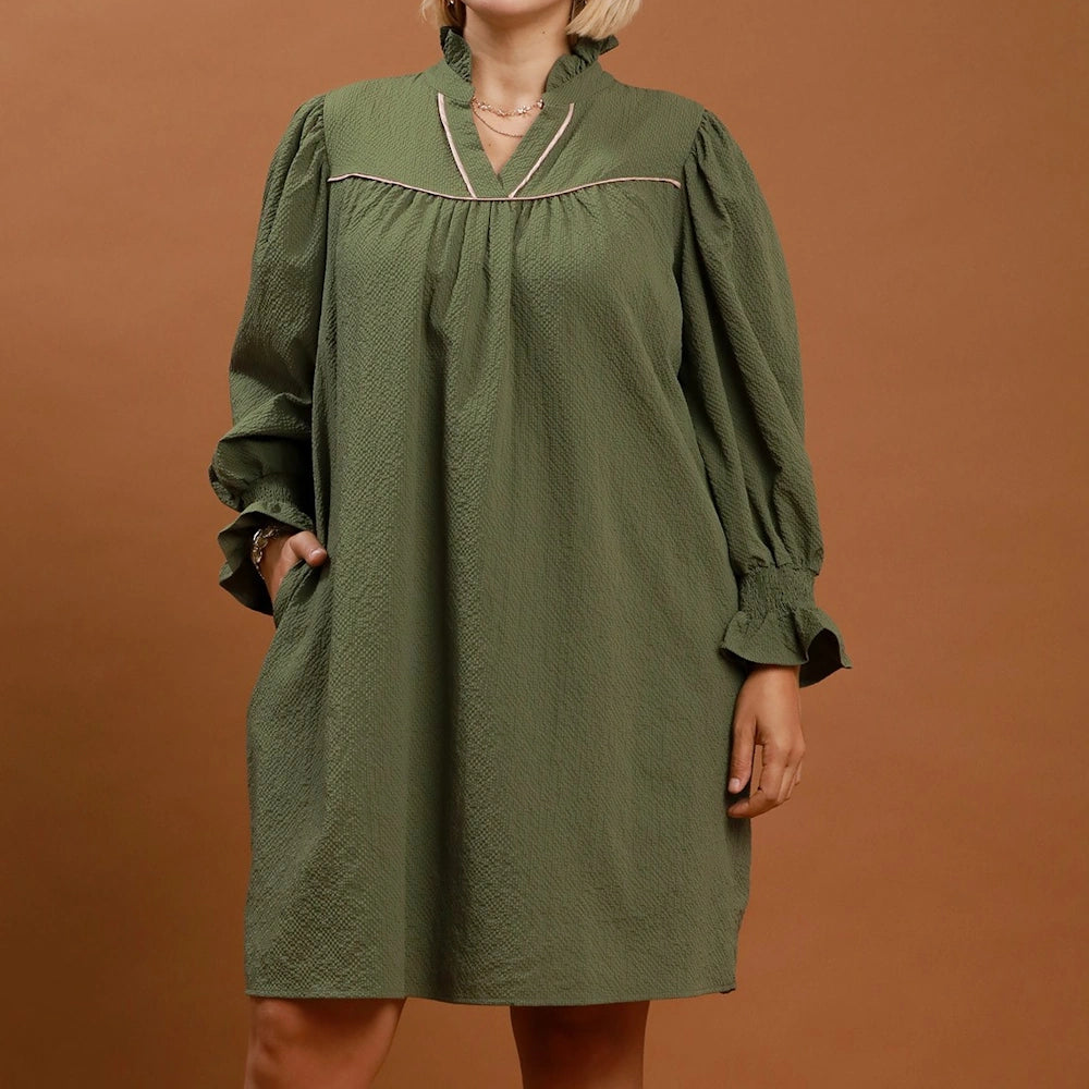 Olive green textured mini dress with long puff sleeves, a ruffled collar, and pink trim accents.