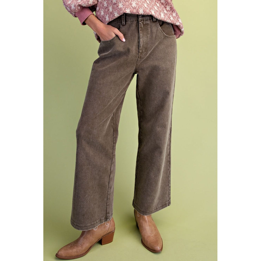Front view of olive green washed wide-leg twill pants with front pockets and tan boots.