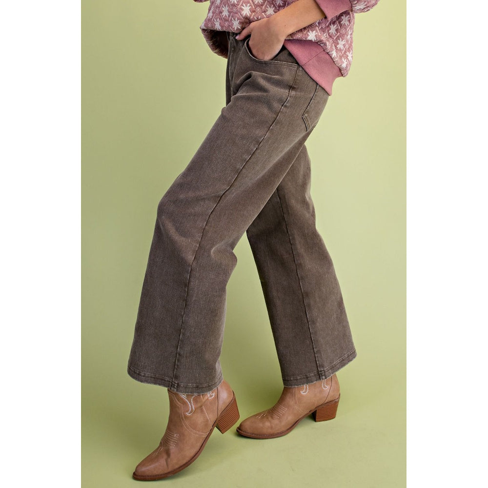 Side profile of olive green washed wide-leg twill pants paired with tan cowboy boots.