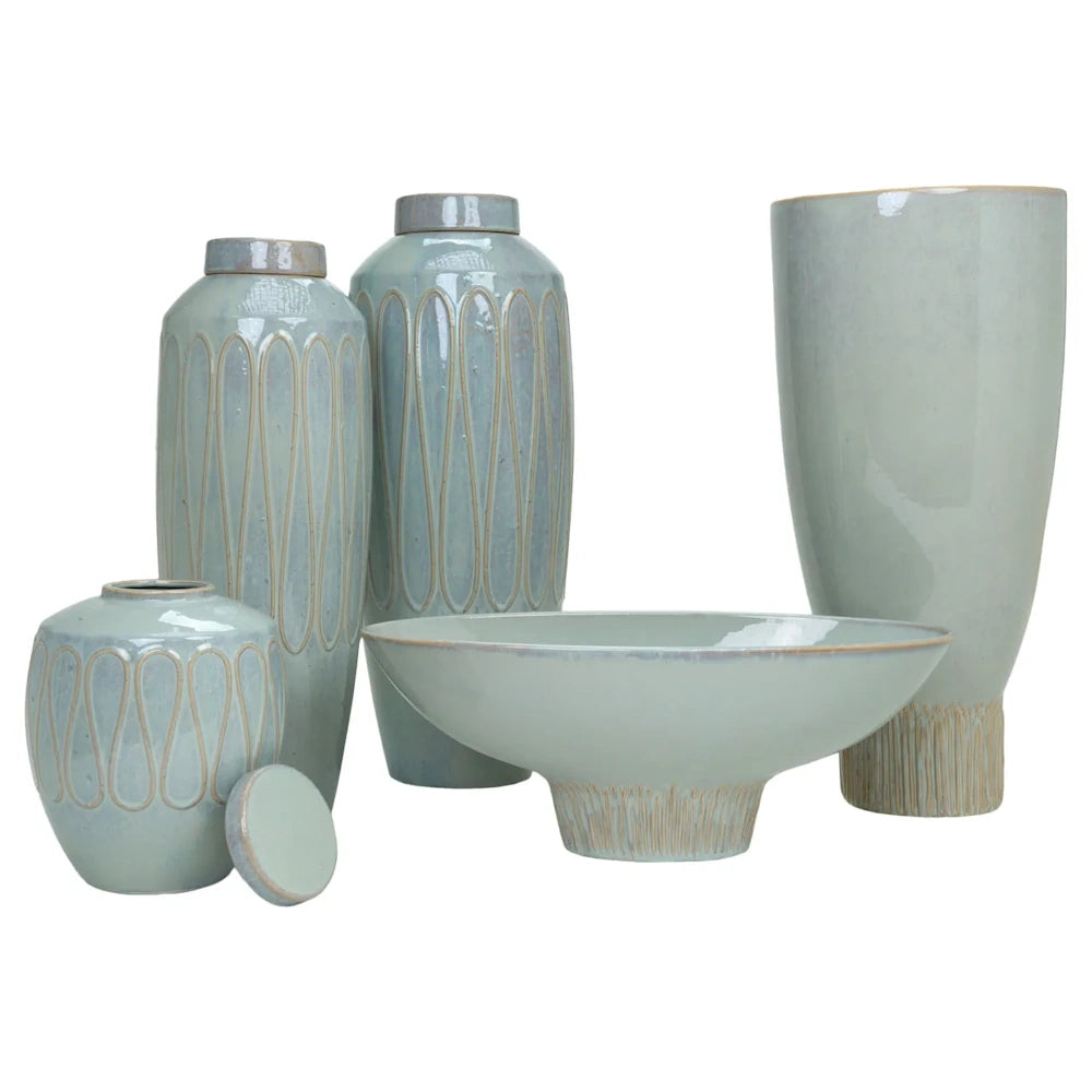 Light sage green ceramic set with textured pattern vases, lidded jars, and a footed bowl.