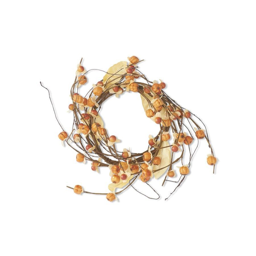 An autumn candle ring made of faux twigs, adorned with orange mini pumpkins, berries, and cream leaves.